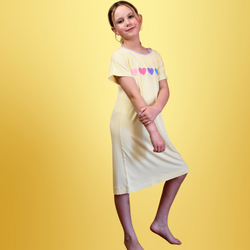 A standing girl wearing lemon loveheart nightdress - nightdresses for women and kids  - from Comfort on the Spectrum.