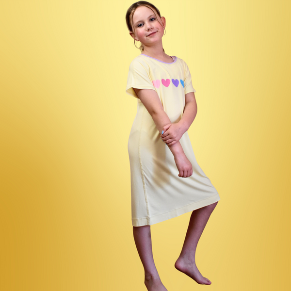 A standing girl wearing lemon loveheart nightdress - nightdresses for women and kids  - from Comfort on the Spectrum.