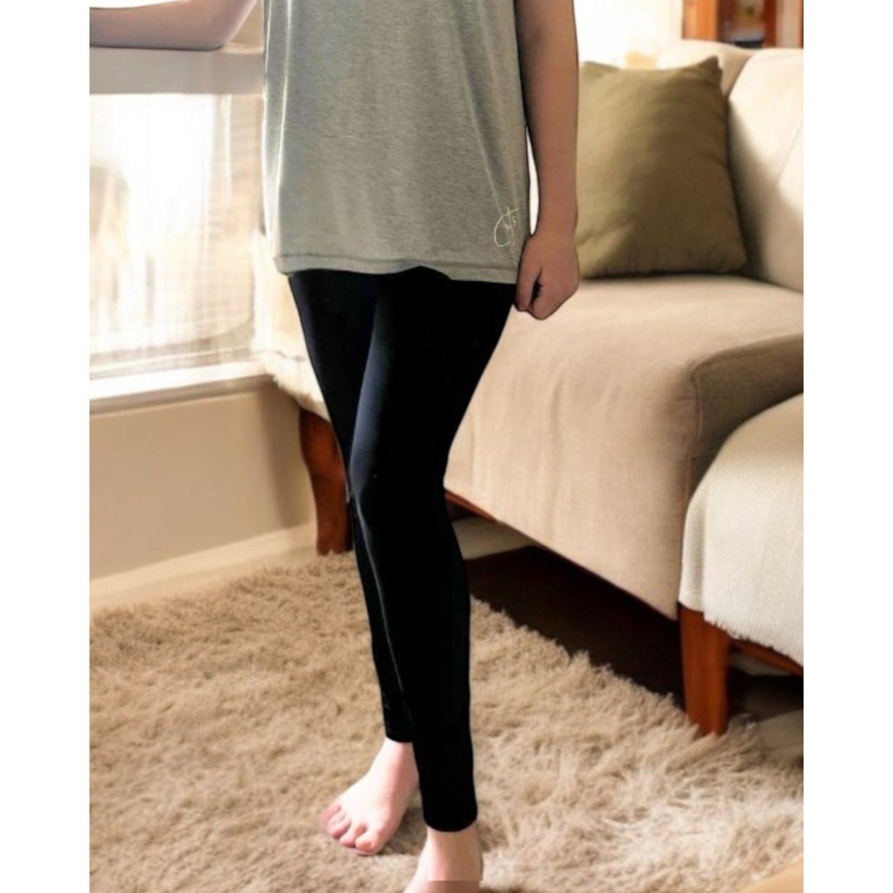 A girl standing wearing the midnight sensory legging from Comfort on the Spectrum.