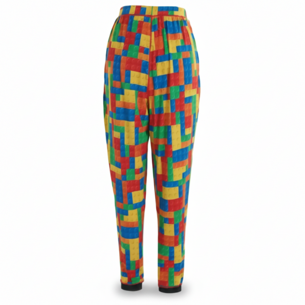 A pair of lounge-style pants with a vibrant, multicolor geometric block pattern in red, orange, yellow, green, and blue, featuring a solid black cuff at the ankles, shown against a plain white background.