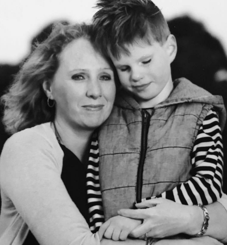 Mum hugging her son, sharing a quiet moment of comfort.