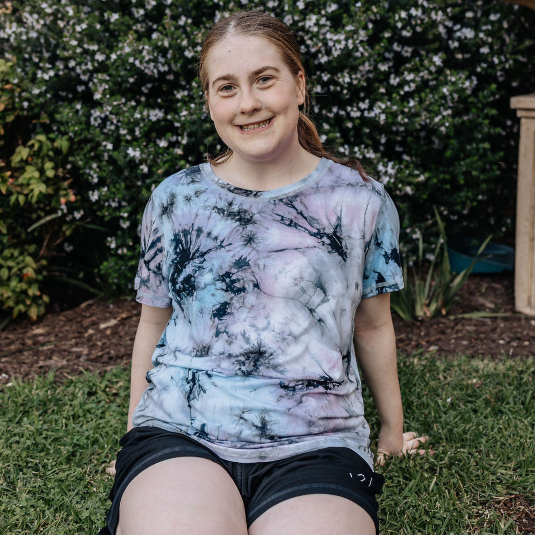 Cosmic Splash bamboo t shirt from Comfort on the Spectrum were worn by a smiling lady.