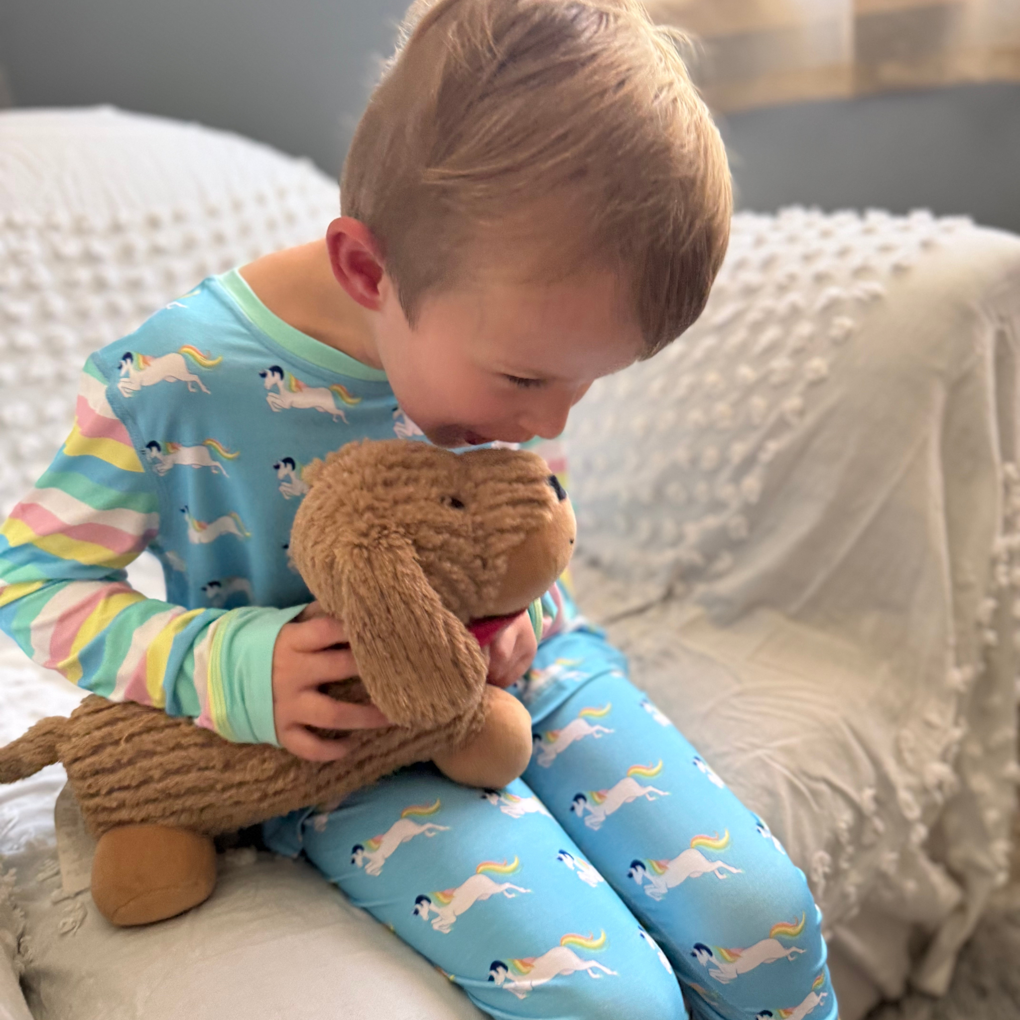 Child hugging a plush toy, showing comfort and emotional support for sensory-sensitive kids.