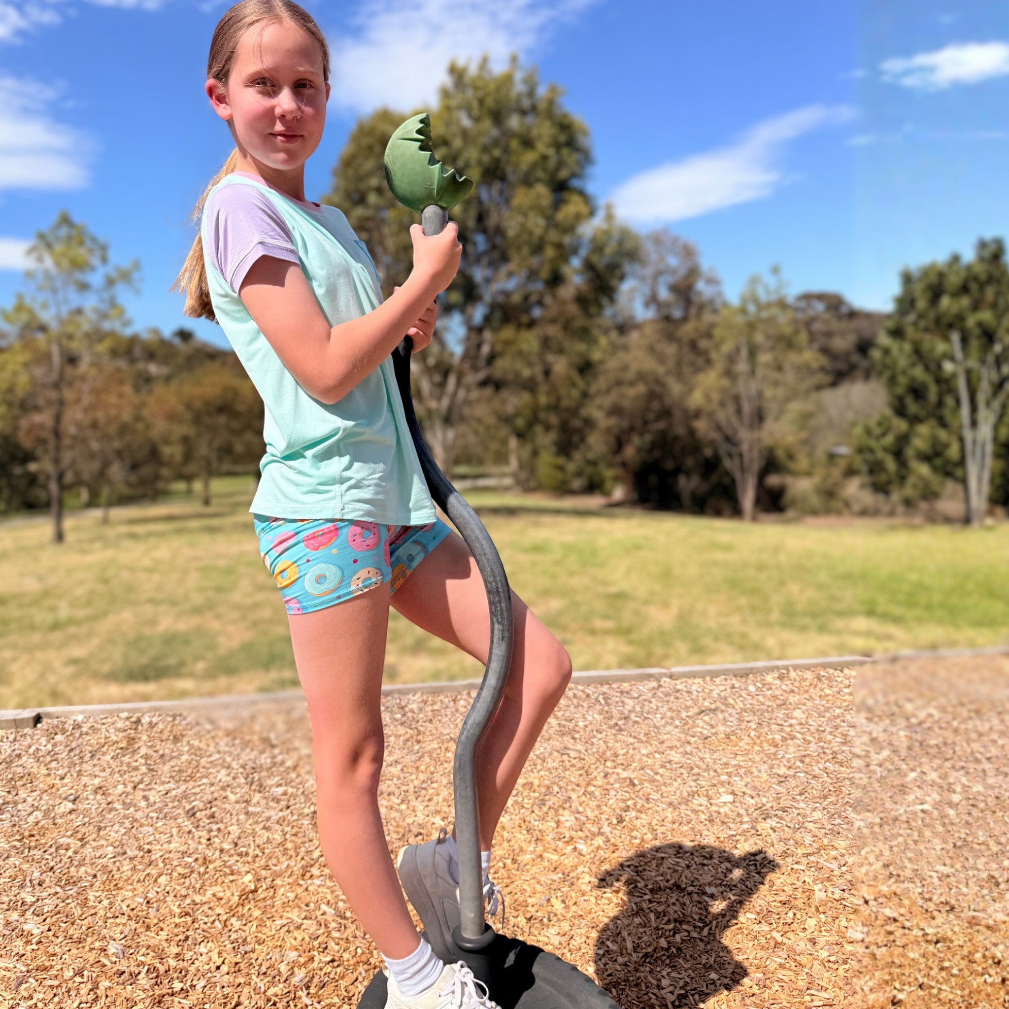 Comfort on the Spectrum kids donut party snug shorts, light blue with colorful donuts, bamboo blend, unisex fit.