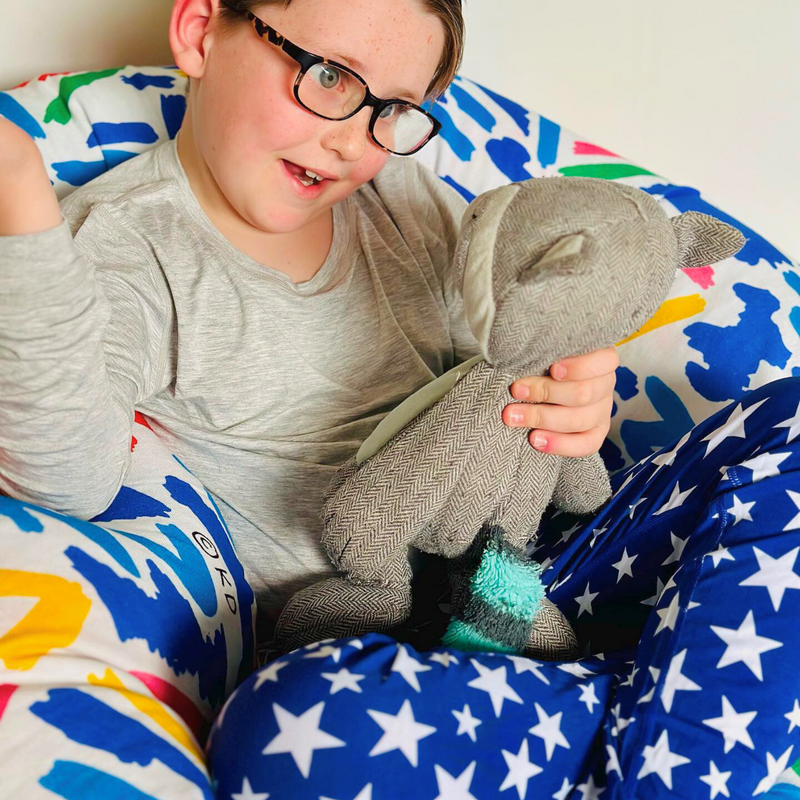 A boy wearing stars  Long Set Pajamas for Teens & Kids from Comfort on the Spectrum.