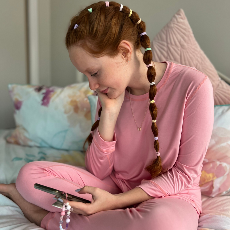 A braided girl wearing candy long set - pajama set for teens- from Comfort on the Spectrum.