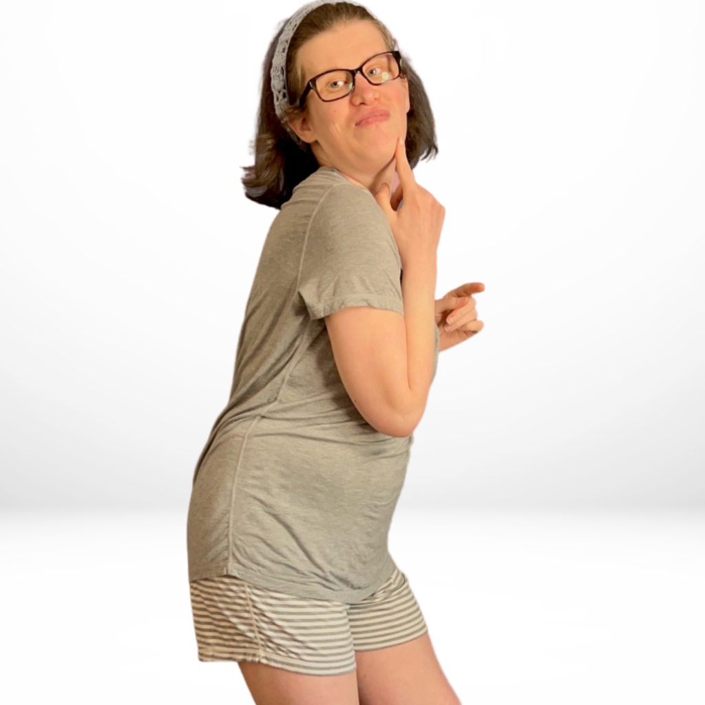 Standing girl posing for photo while wearing the grey stripe short  - the bamboo short pyjamas from Comfort on the Spectrum.