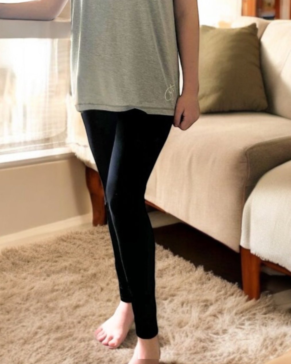 A girl standing wearing the midnight sensory legging from Comfort on the Spectrum.