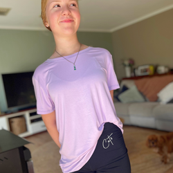A standing girl wearing the lavender bamboo t shirt from Comfort on the Spectrum | sensory clothing for adults