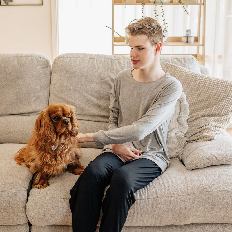 The Midnight Lounge Pants women and grey marle basic long sleeve tops for adults from Comfort on the Spectrum were worn by a smiling man while petting a dog.