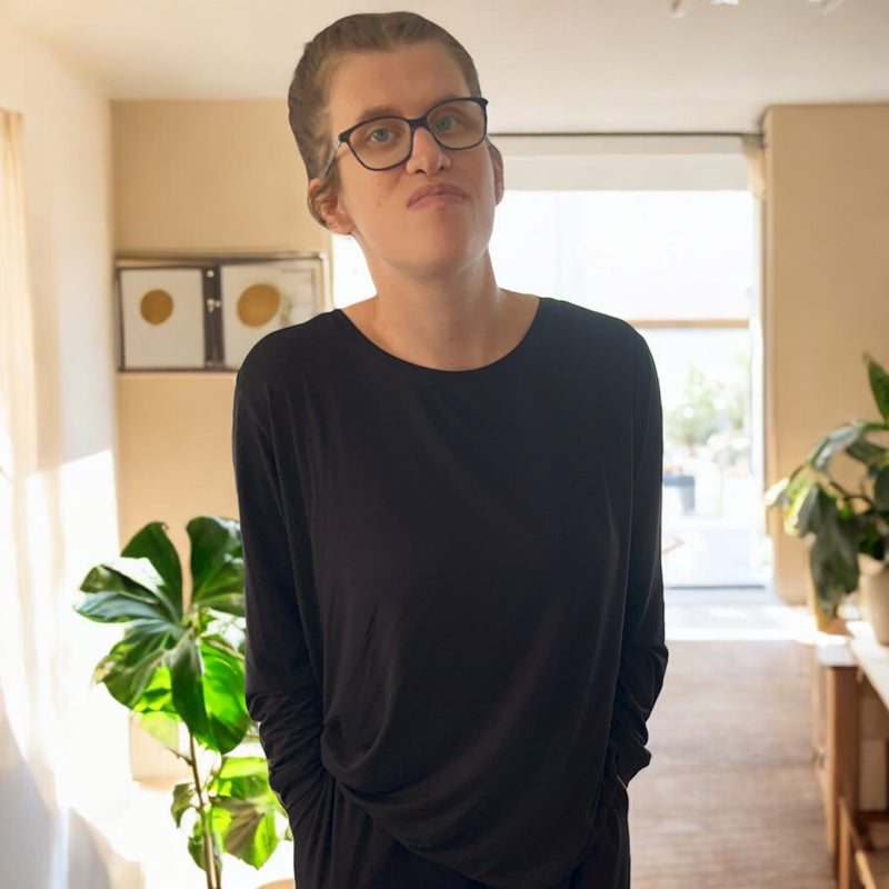 A woman standing wearing the midnight long sleeve top , a basic long sleeve tops from Comfort on the Spectrum.