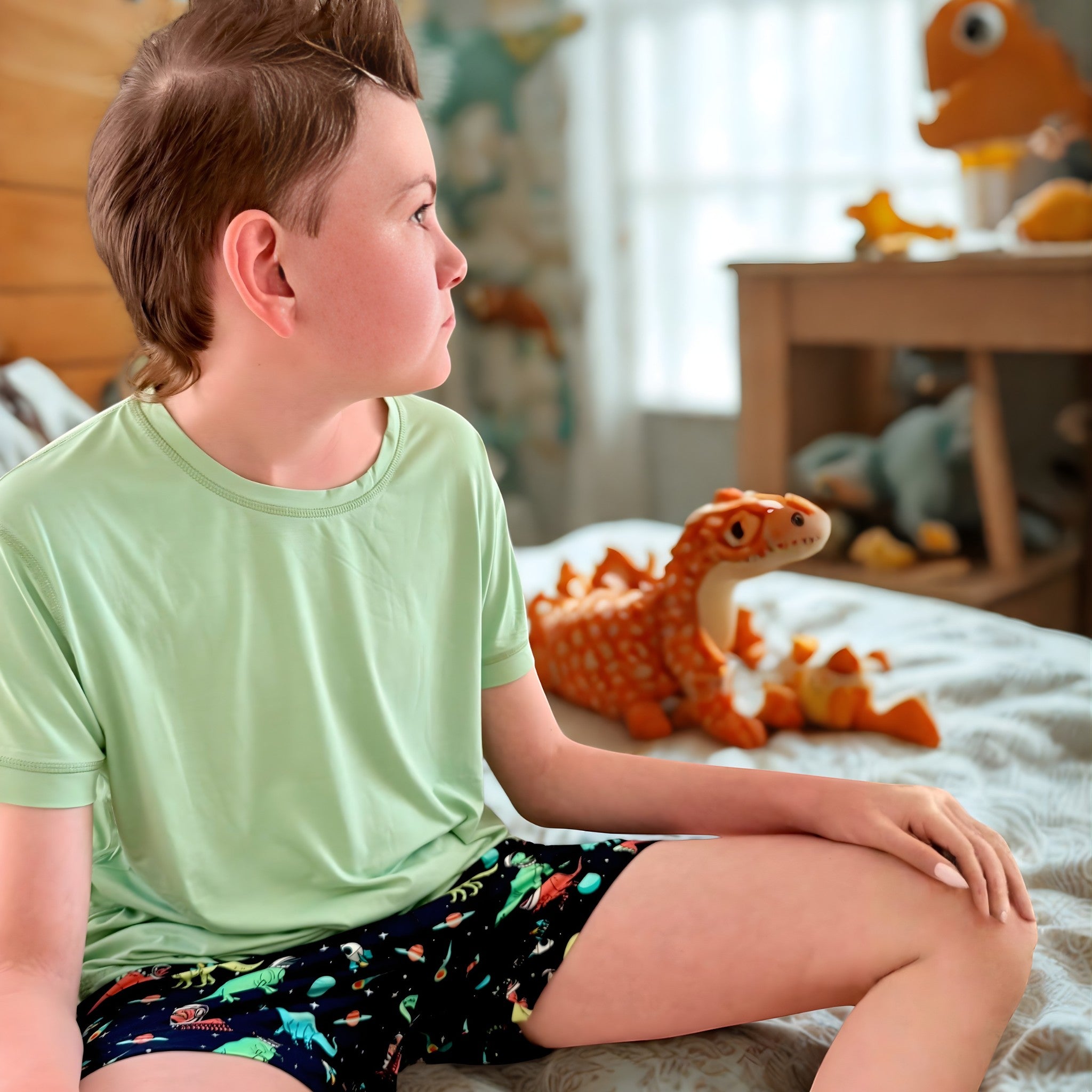 Comfort on the Spectrum light green bamboo short set with black space dinosaur print shorts for kids.