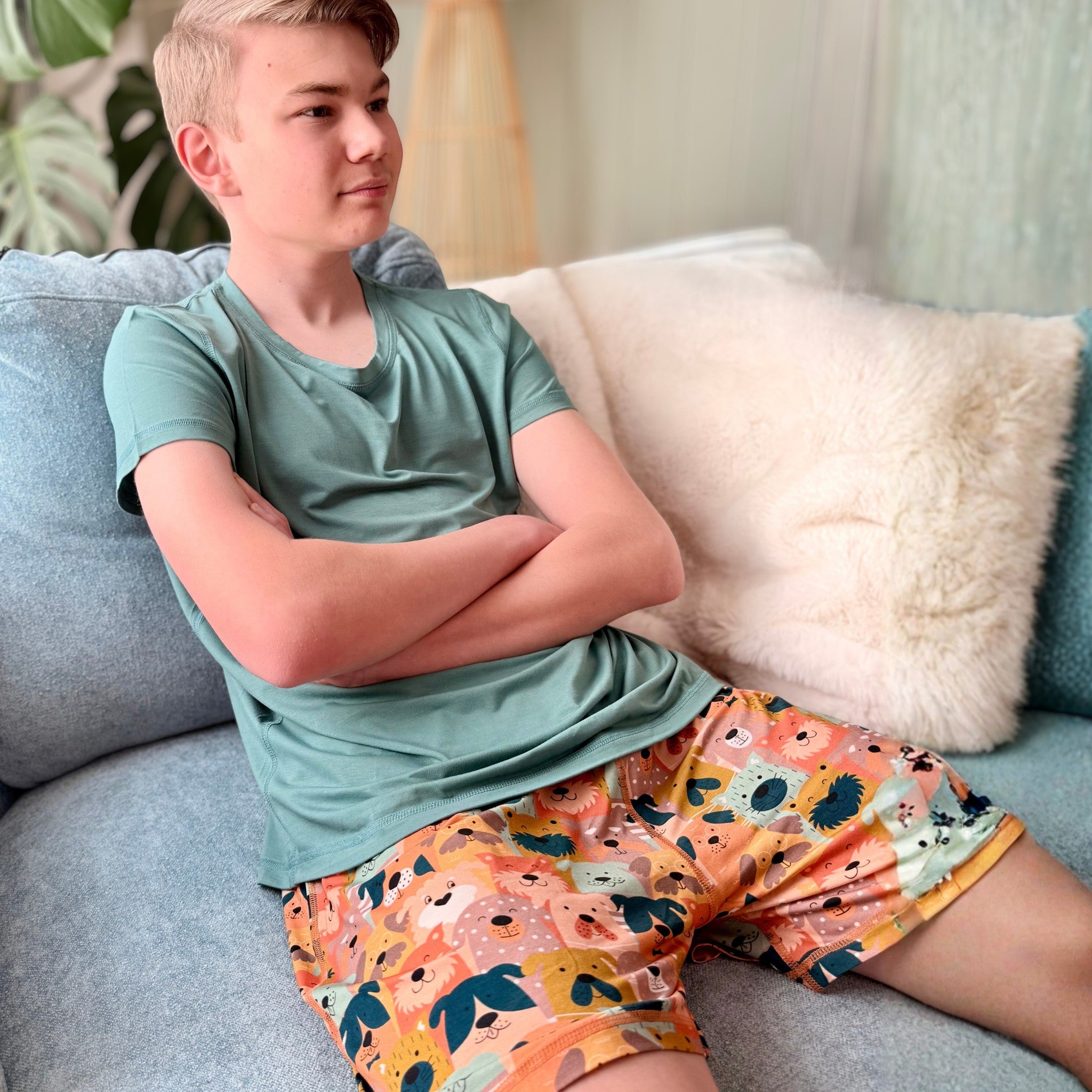 Comfort on the Spectrum adult sensory-friendly shorts in puppy paws print. Peach shorts with flat seams, pockets, and a relaxed fit.