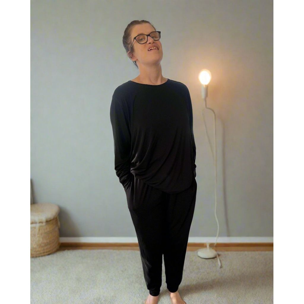 A standing woman wearing midnight long pajama set - long set from Comfort on the Spectrum.
